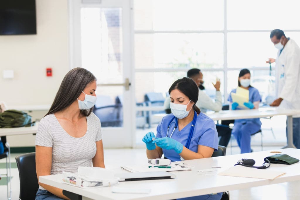 Physician prepares to bandage a patient's arm