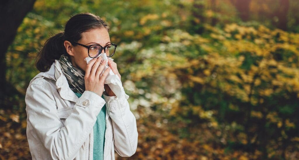 Woman blowing her nose.